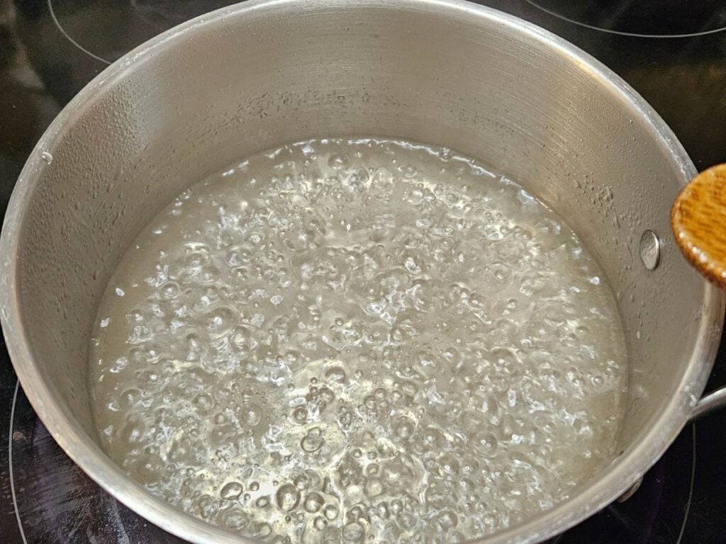 simple syrup boiling in a saucepan