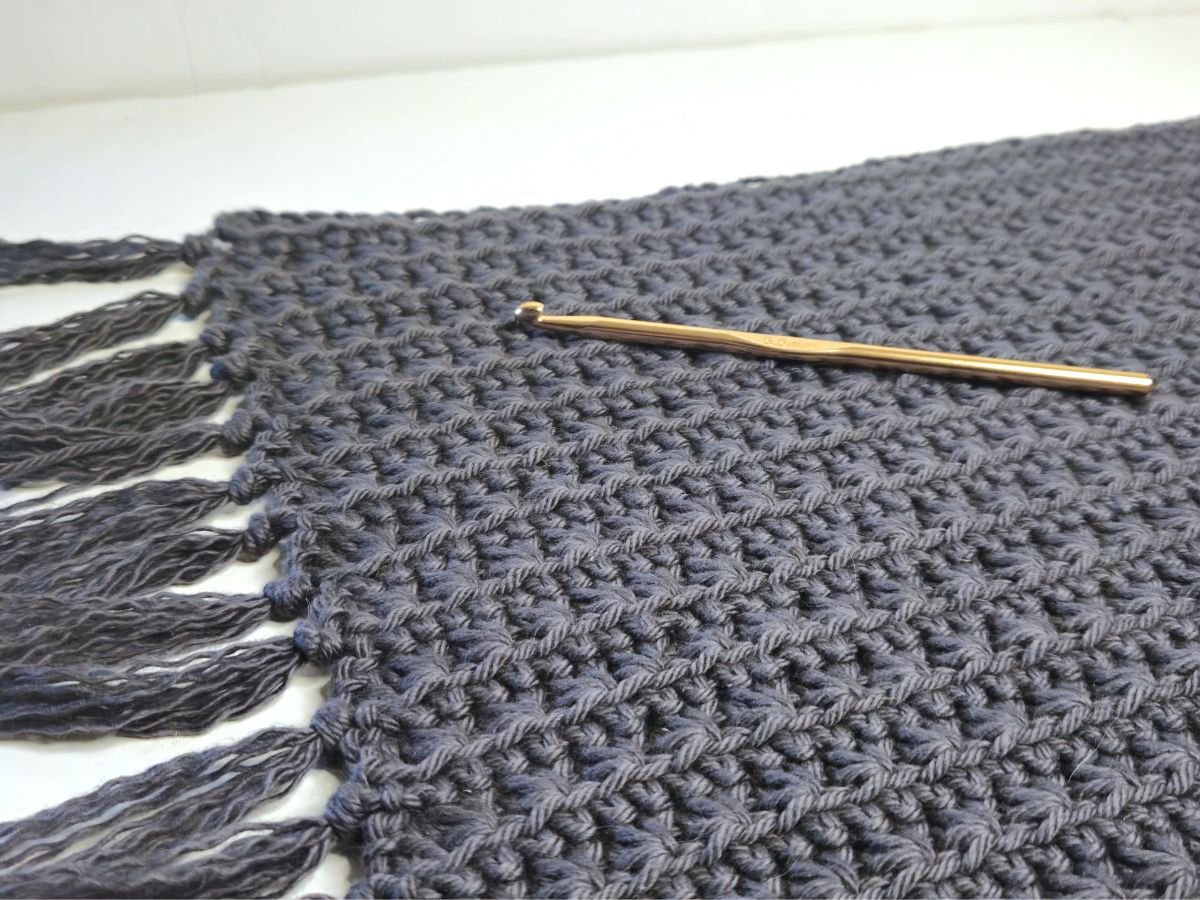 a crochet placemat with a crochet hook
