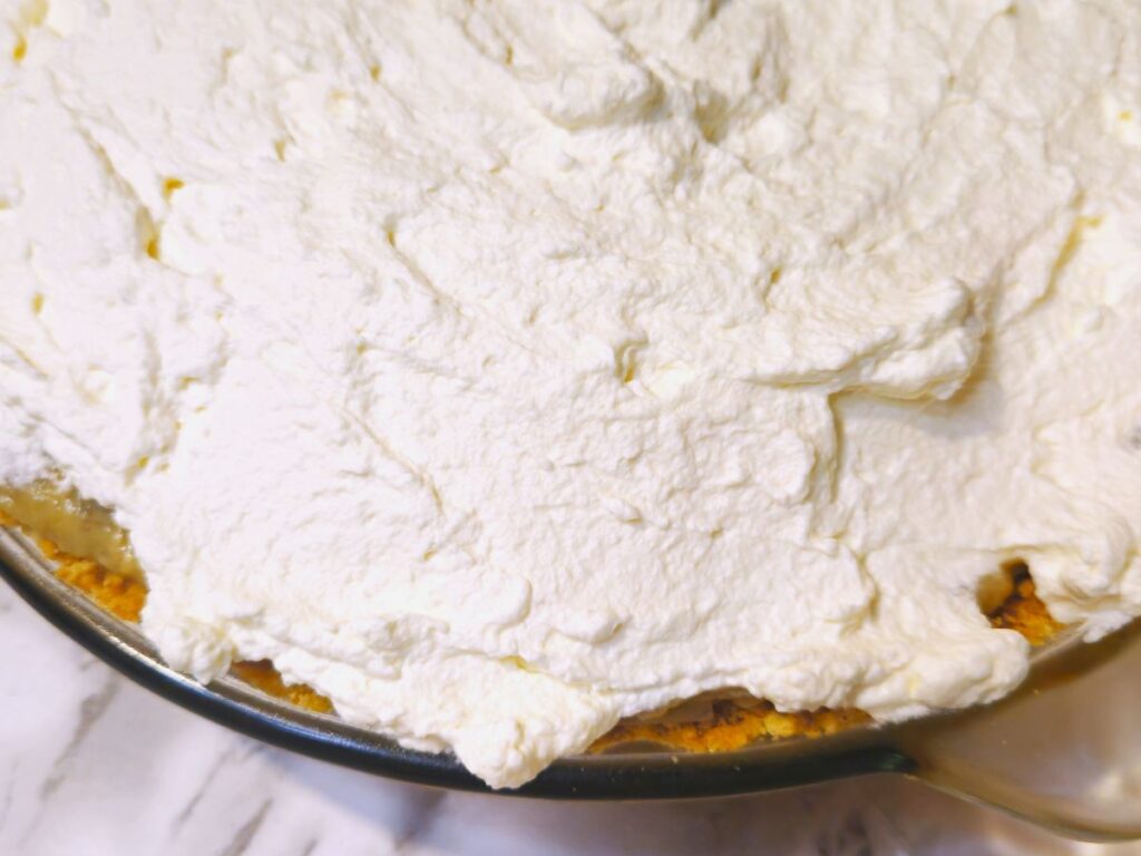 whipped cream topping on a banana cream pie