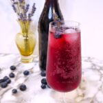 a glass of sparkling lavender blueberry cordial