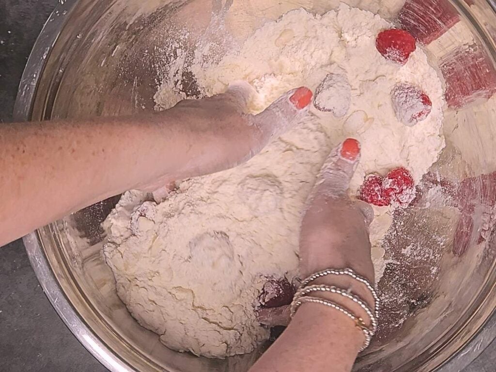 gently adding the raspberries to to the scone mixture