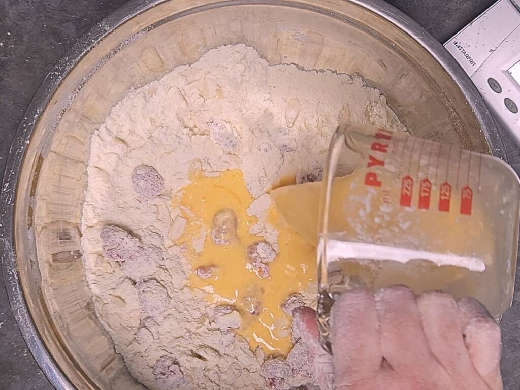 pouring egg and buttermilk into scone ingredients
