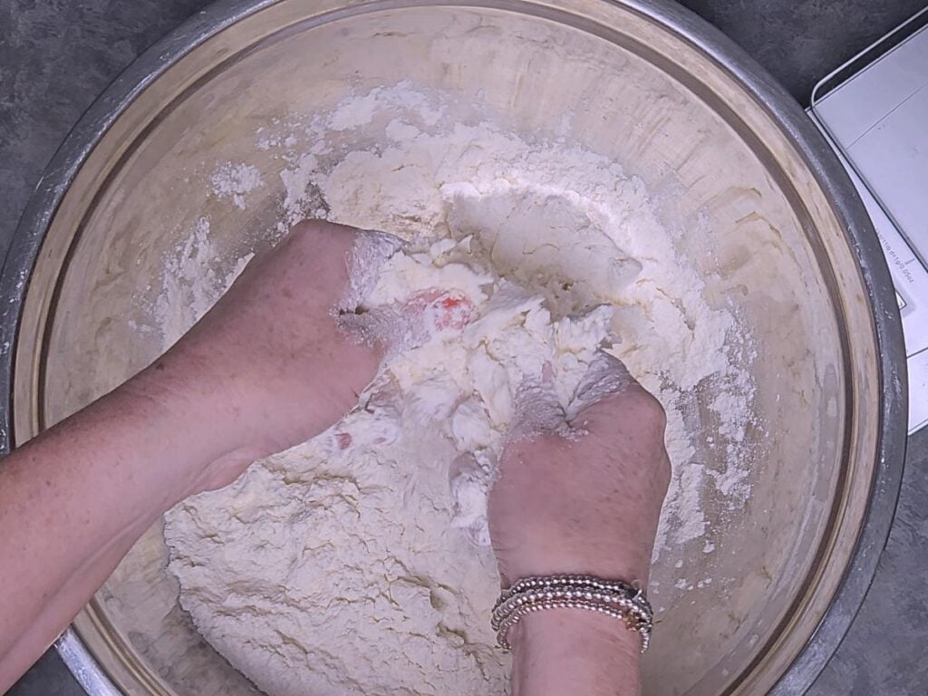 fingertips rubbing butter into flour