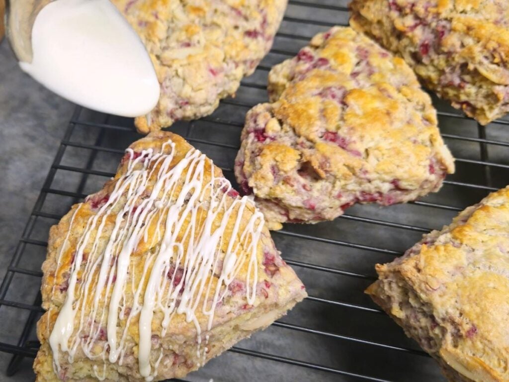 drizzling melted white chocolate over almond raspberry scones