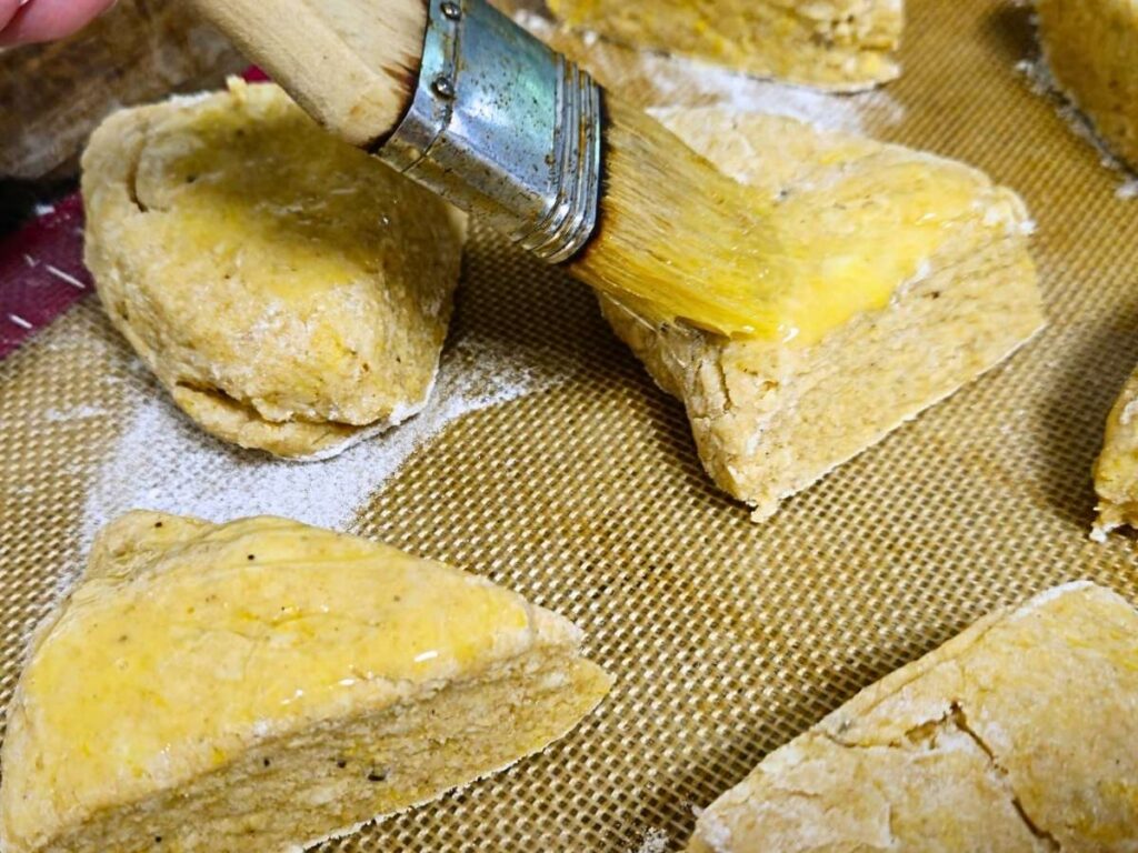 pastry brush brushing egg onto scones